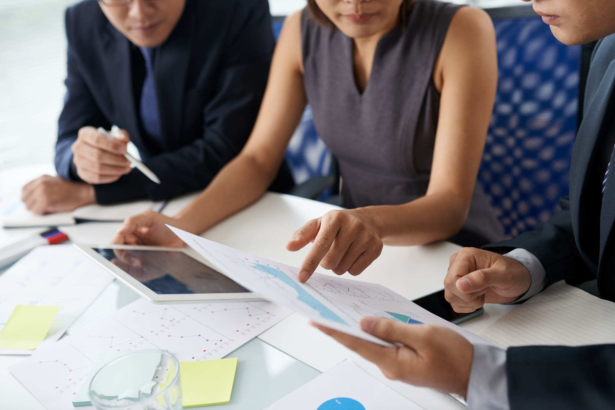 Entrepreneurs discussing charts and graphs at annual meeting